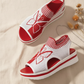 Red sandals cream background no text